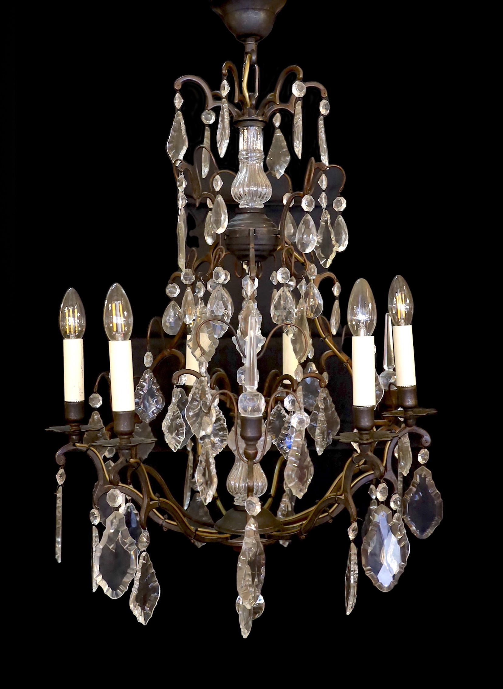 A French style patinated brass and cut glass eight light chandelier on with lozenge drops, drop 90cm. width 60cm